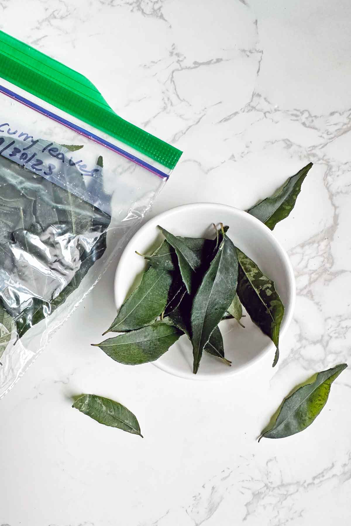 frozen curry leaves in a bowl.