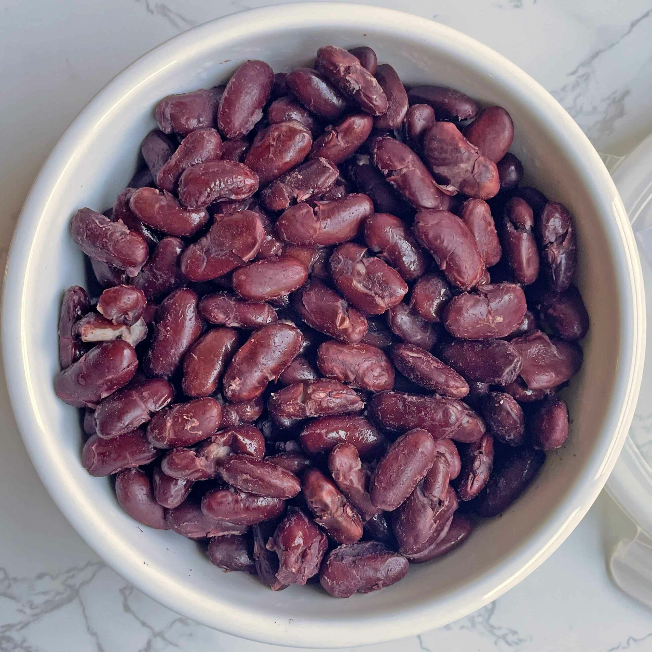 Pressure cooked rajma beans in a container.