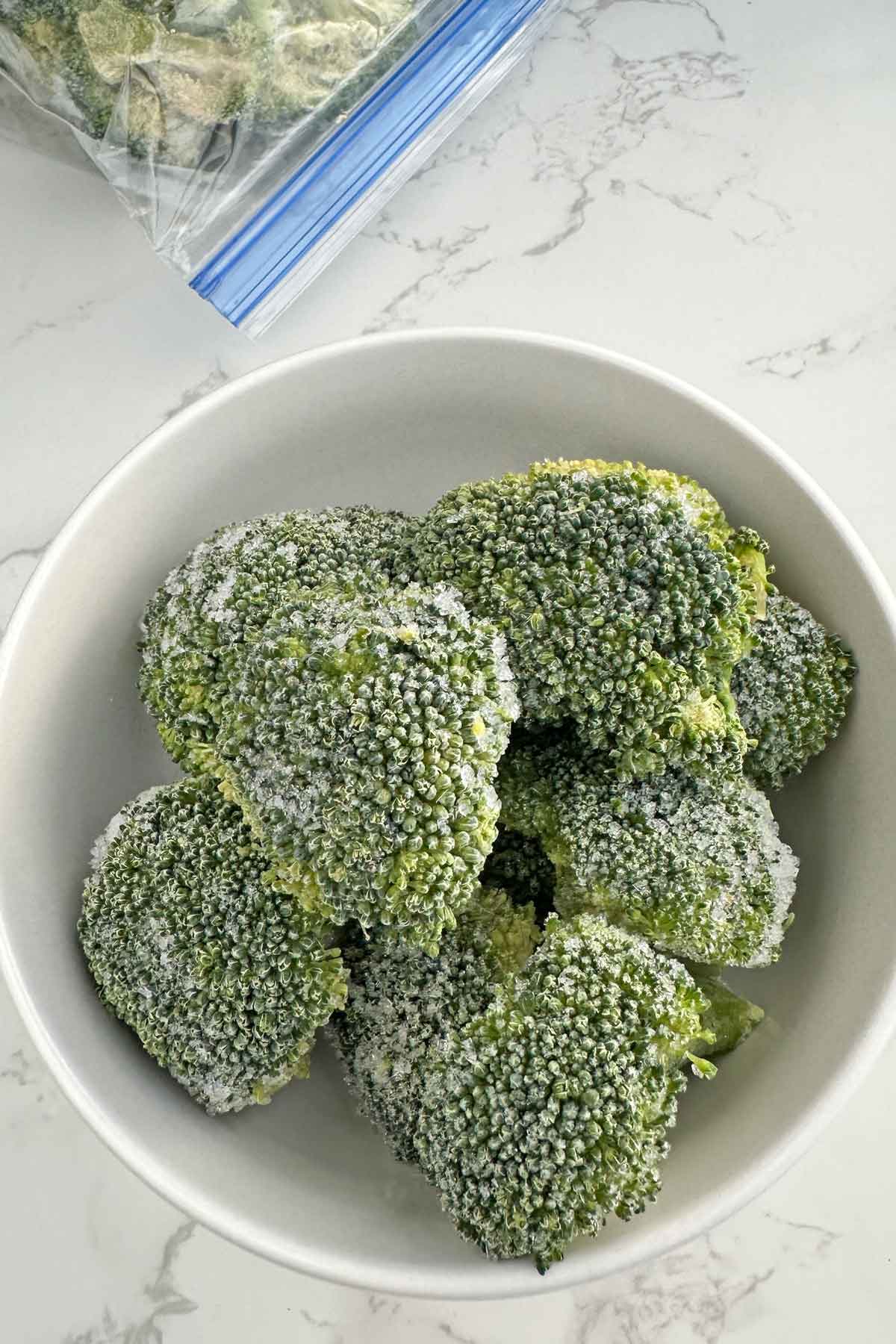 frozen broccoli florets in a bowl.