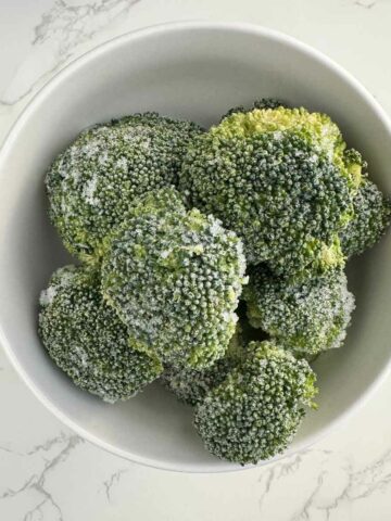 frozen broccoli florets in a bowl.