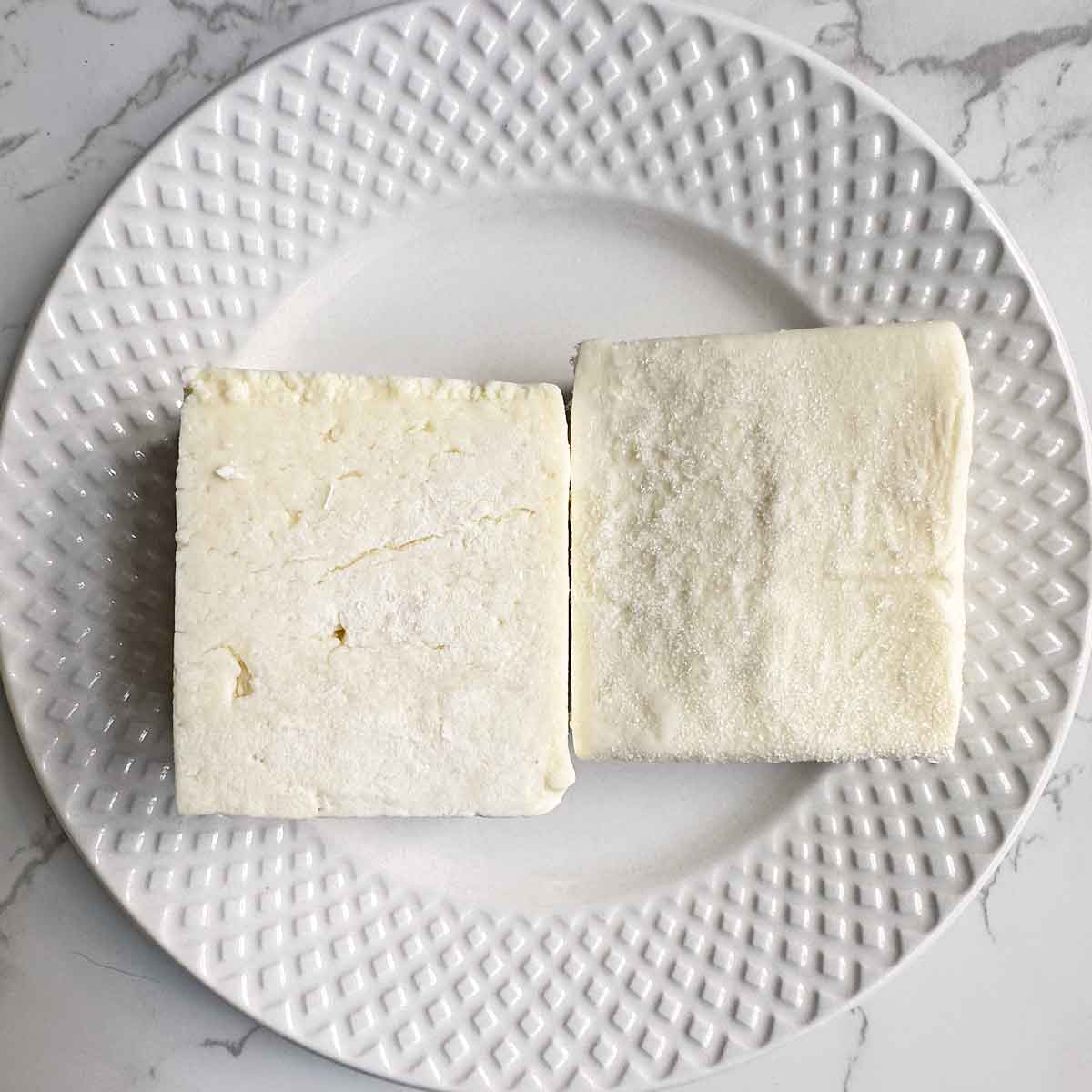 frozen paneer slices in a plate.