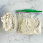 frozen buttercream frosting in a container and ziplock bag.