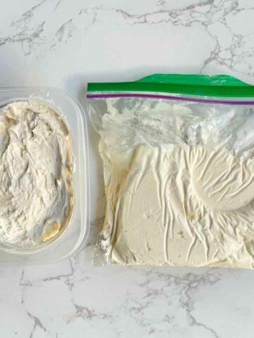 frozen buttercream frosting in a container and ziplock bag.