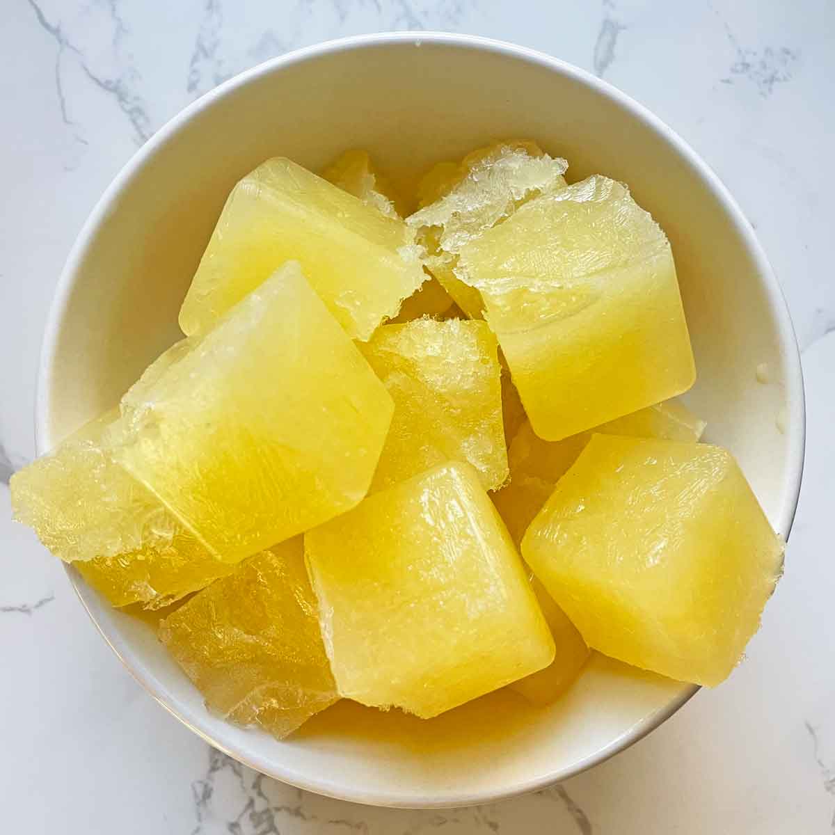frozen lemon juice cubes in a bowl.
